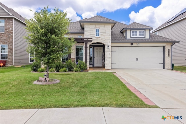 view of front facade featuring a garage and a front yard