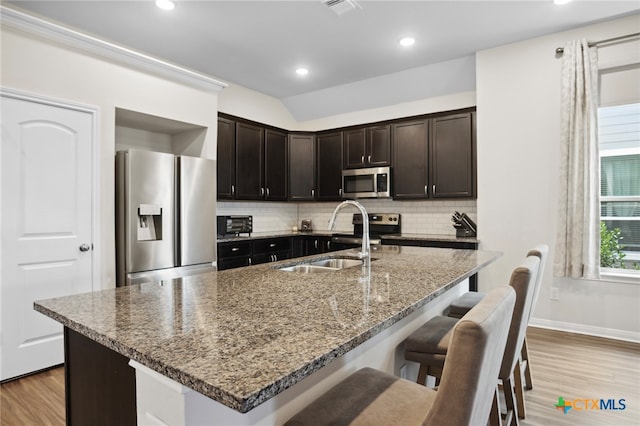 kitchen with stainless steel appliances, plenty of natural light, sink, and tasteful backsplash