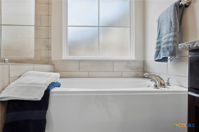 bathroom featuring a tub to relax in