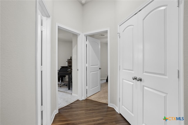 hall with dark wood-type flooring