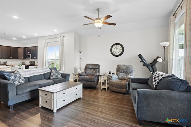 living room with dark wood-type flooring and ceiling fan