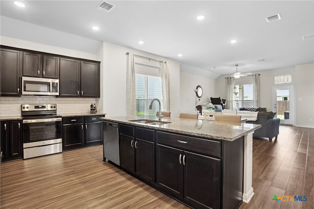 kitchen featuring light hardwood / wood-style floors, plenty of natural light, sink, and appliances with stainless steel finishes