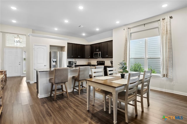 dining room with a notable chandelier and dark hardwood / wood-style floors