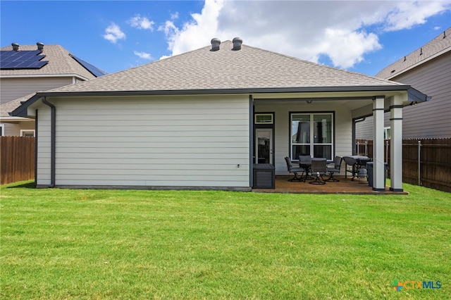 back of property featuring a patio, ceiling fan, and a yard