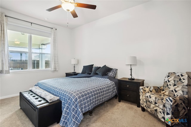 bedroom featuring light carpet and ceiling fan