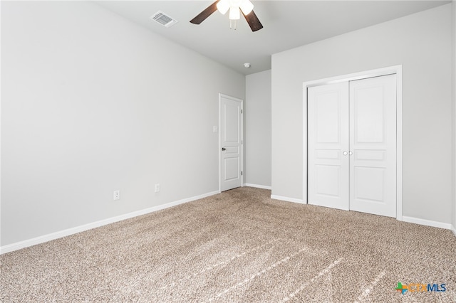 unfurnished bedroom with carpet, ceiling fan, and a closet