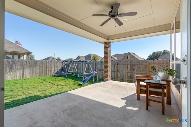 view of patio / terrace with ceiling fan and a playground