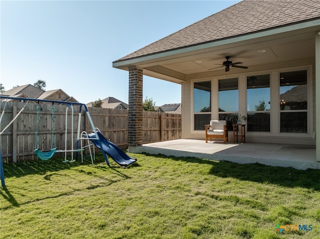 view of yard with a playground, ceiling fan, and a patio