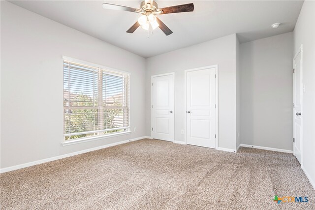 unfurnished bedroom featuring carpet and ceiling fan