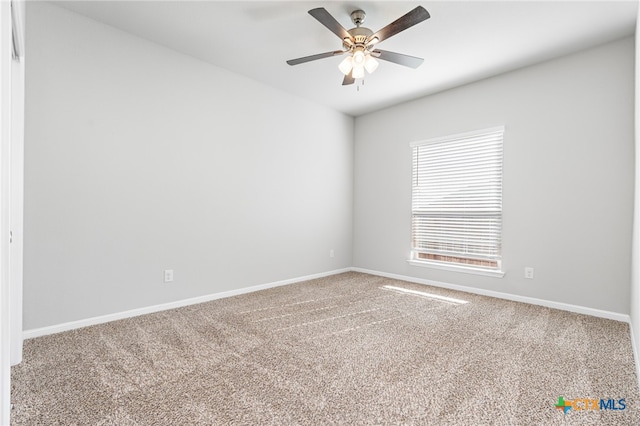 carpeted spare room with ceiling fan