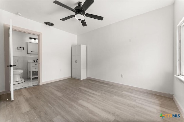 1814 S 5th St, Temple, TX 76504 - unfurnished bedroom featuring light wood finished floors, ensuite bath, and a ceiling fan