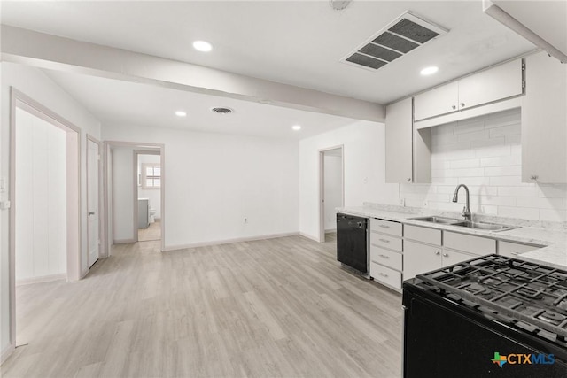 1814 S 5th St, Temple, TX 76504 - kitchen with black appliances, light wood-style flooring, white cabinetry, backsplash, and recessed lighting