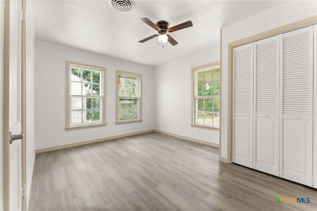 1814 S 5th St, Temple, TX 76504 - unfurnished bedroom featuring wood finished floors, ornamental molding, a closet, and a ceiling fan