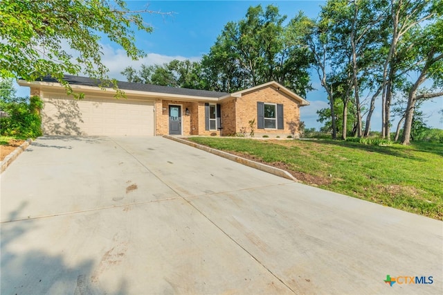 4013 Valley View Dr, Temple, TX 76502 - single story home featuring concrete driveway, a garage, brick siding, and a front yard