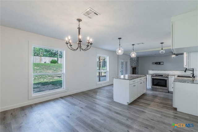 4013 Valley View Dr, Temple, TX 76502 - kitchen with stainless steel range with electric stovetop, a sink, plenty of natural light, and white cabinets