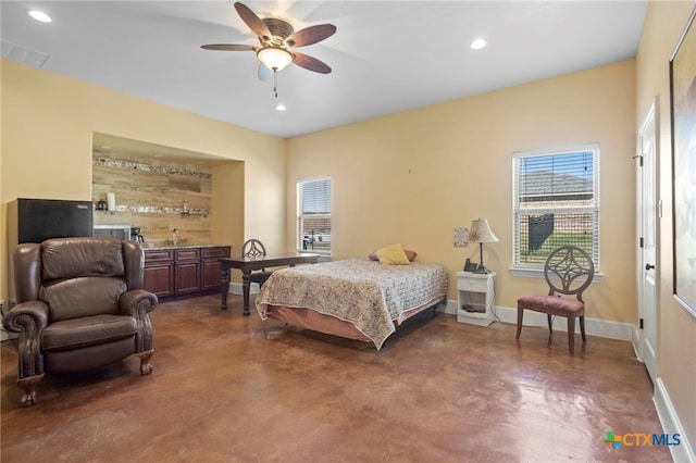 bedroom with ceiling fan and concrete floors