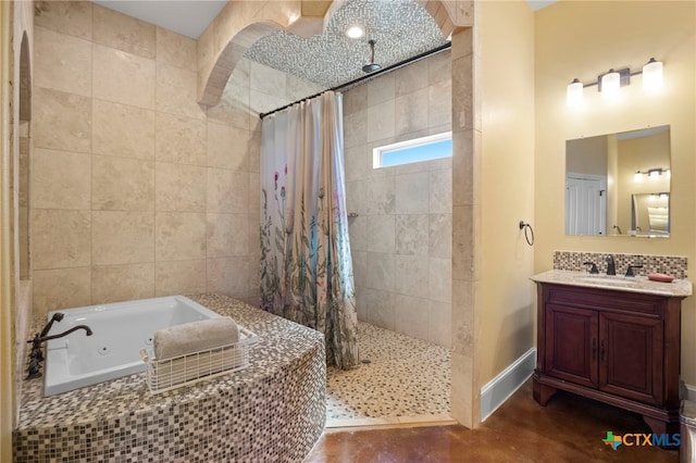 bathroom with vanity and independent shower and bath