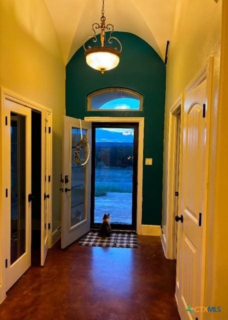 foyer entrance featuring lofted ceiling and french doors