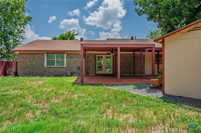 409 W Mary Jane Dr, Killeen, TX 76541 - rear view of property featuring a ceiling fan, a lawn, a patio area, and french doors