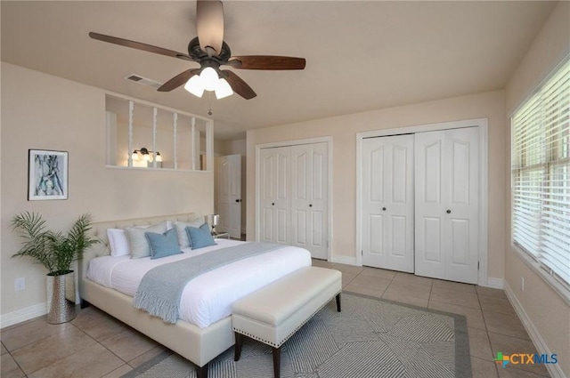 409 W Mary Jane Dr, Killeen, TX 76541 - bedroom featuring two closets, light tile patterned floors, and a ceiling fan