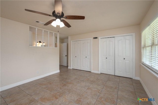 409 W Mary Jane Dr, Killeen, TX 76541 - unfurnished bedroom featuring multiple closets, a ceiling fan, and light tile patterned floors
