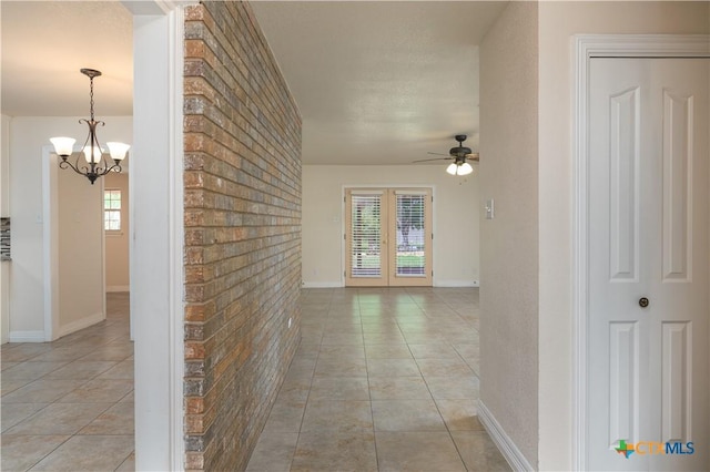 409 W Mary Jane Dr, Killeen, TX 76541 - hallway with a chandelier, light tile patterned floors, and brick wall