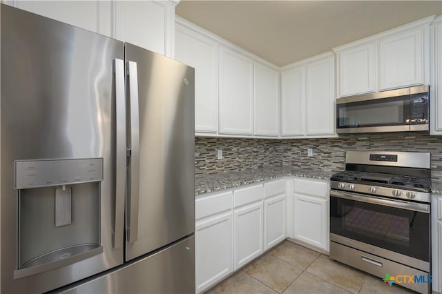 409 W Mary Jane Dr, Killeen, TX 76541 - kitchen featuring stainless steel appliances, light tile patterned floors, tasteful backsplash, and white cabinets
