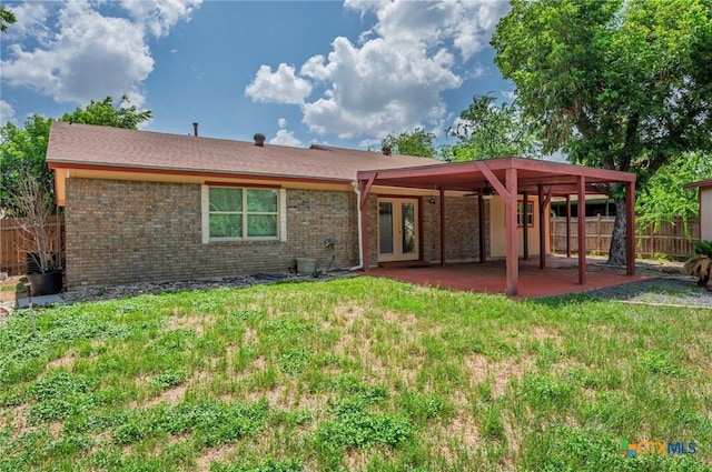 409 W Mary Jane Dr, Killeen, TX 76541 - back of house featuring french doors, a patio, and brick siding