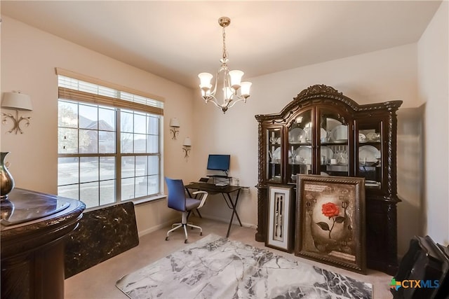 office with a notable chandelier and light colored carpet