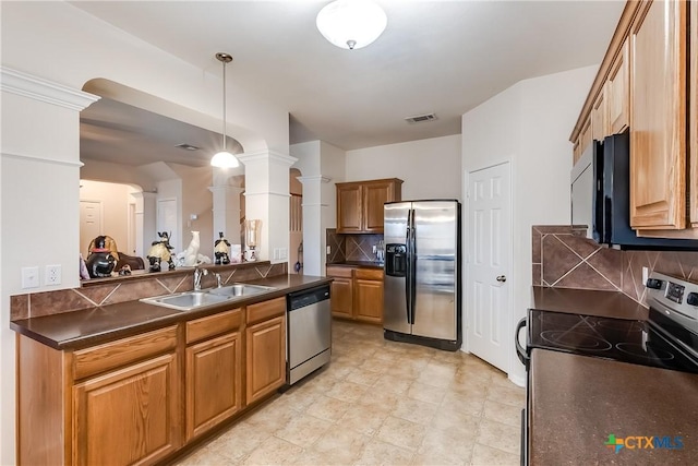 kitchen with sink, ornate columns, tasteful backsplash, hanging light fixtures, and stainless steel appliances