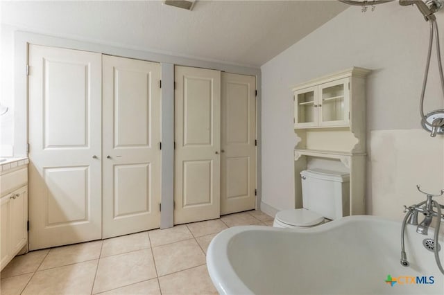 bathroom with tile patterned flooring, vanity, and toilet