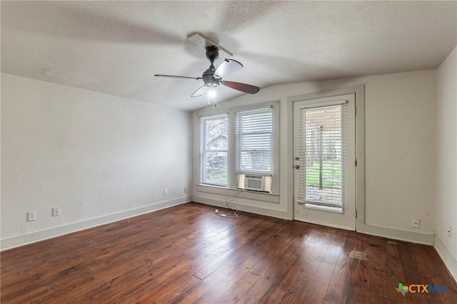 unfurnished room with lofted ceiling, dark wood-type flooring, ceiling fan, cooling unit, and a textured ceiling