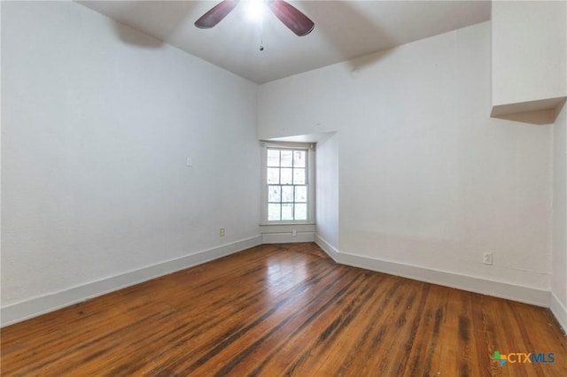 spare room featuring ceiling fan and dark hardwood / wood-style flooring