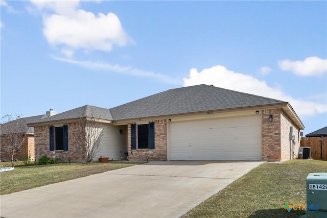 ranch-style home with a front lawn, a garage, and central AC unit