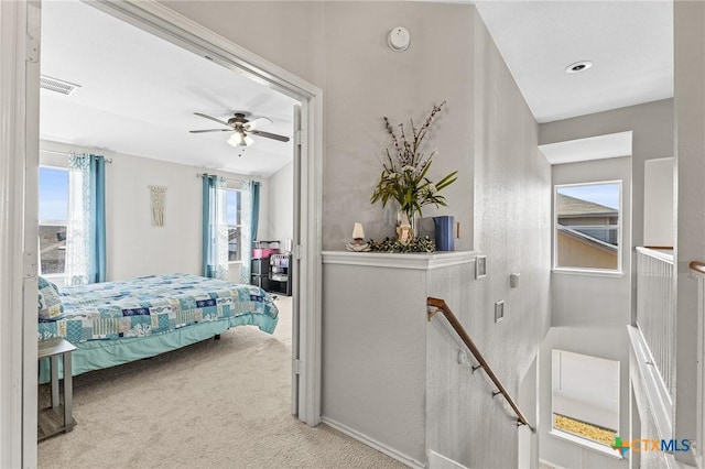 carpeted bedroom featuring visible vents and a ceiling fan