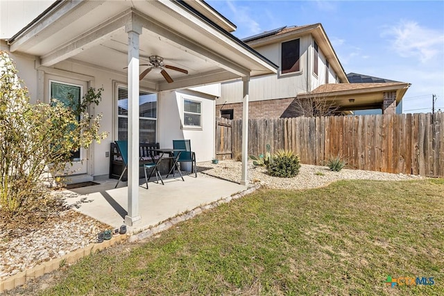 view of yard with a patio, fence, and a ceiling fan