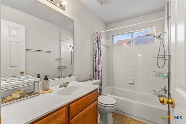 full bathroom with visible vents, toilet, shower / bath combo, vanity, and tile patterned flooring