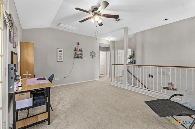 office area with carpet, visible vents, a ceiling fan, vaulted ceiling, and baseboards