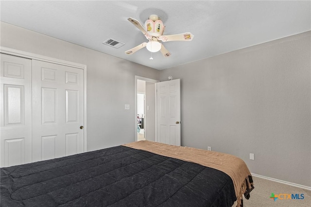 bedroom with carpet flooring, visible vents, baseboards, a ceiling fan, and a closet