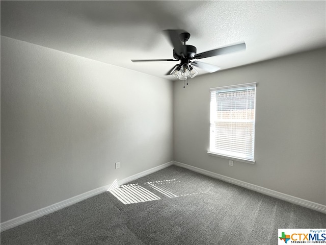 spare room featuring ceiling fan and carpet flooring