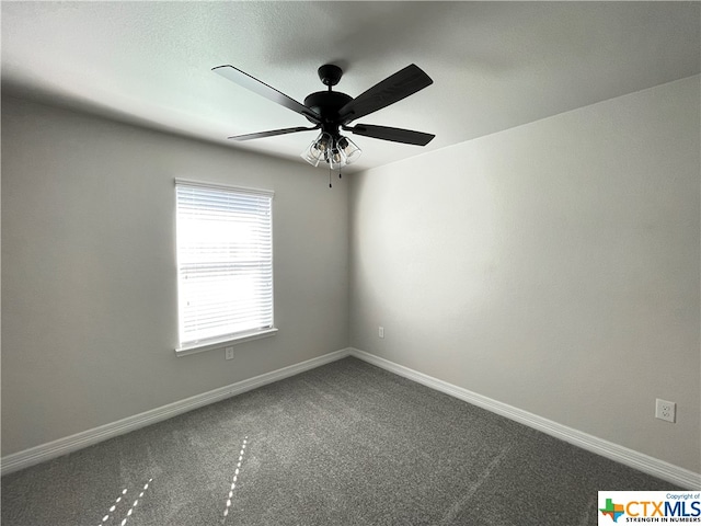 carpeted spare room with ceiling fan