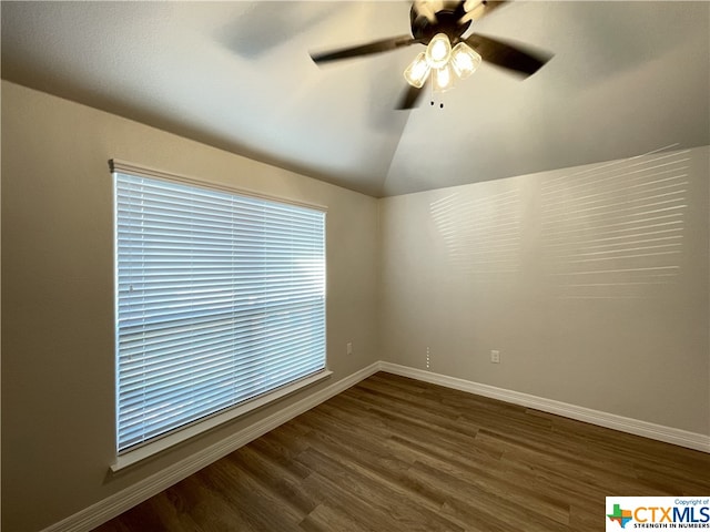 empty room with dark wood-type flooring, vaulted ceiling, and ceiling fan