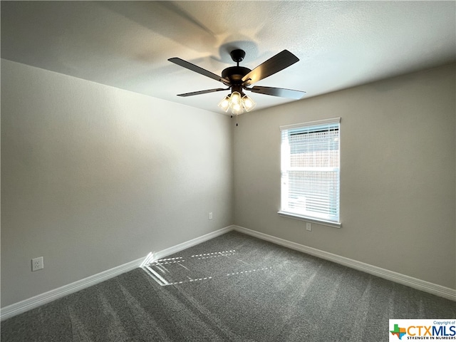 unfurnished room featuring dark colored carpet and ceiling fan