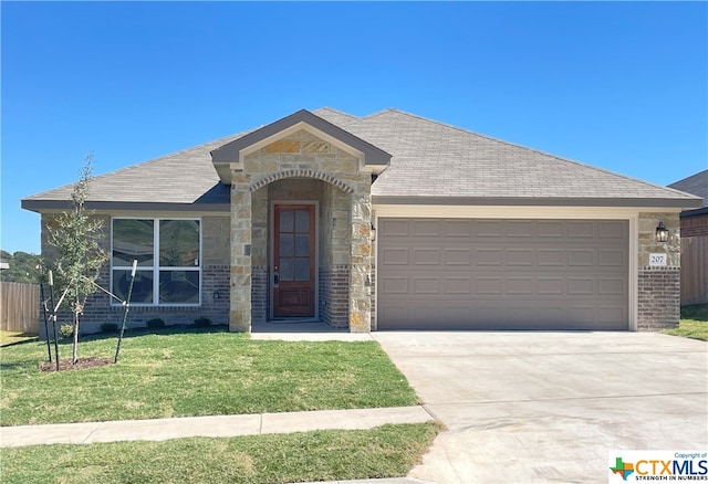 view of front of home featuring a garage and a front yard