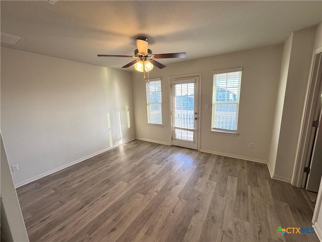 empty room featuring ceiling fan and hardwood / wood-style flooring