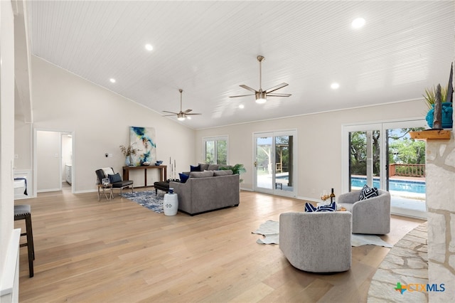 living room featuring baseboards, recessed lighting, light wood-type flooring, and plenty of natural light