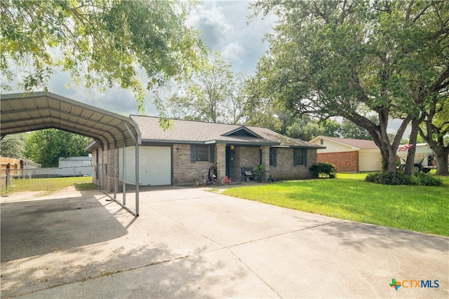 single story home featuring a garage, a front yard, and a carport