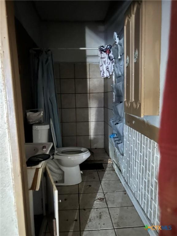 bathroom featuring tile patterned flooring and toilet