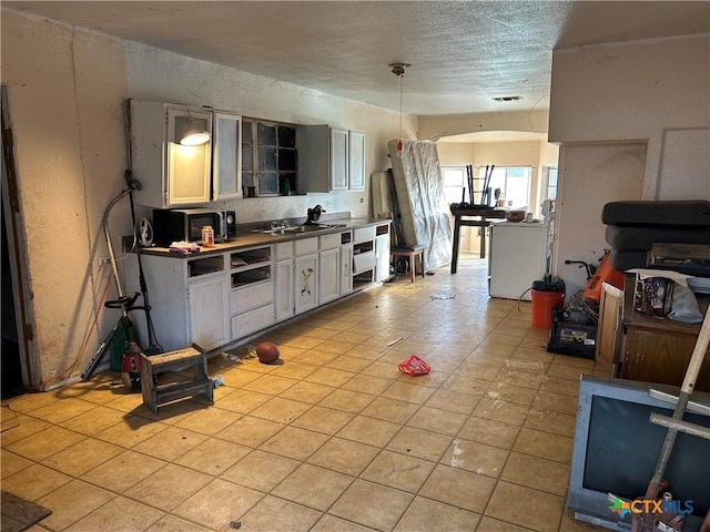 kitchen featuring light tile patterned floors and a textured ceiling