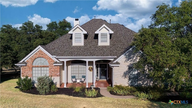 view of front of house with a front lawn and a porch